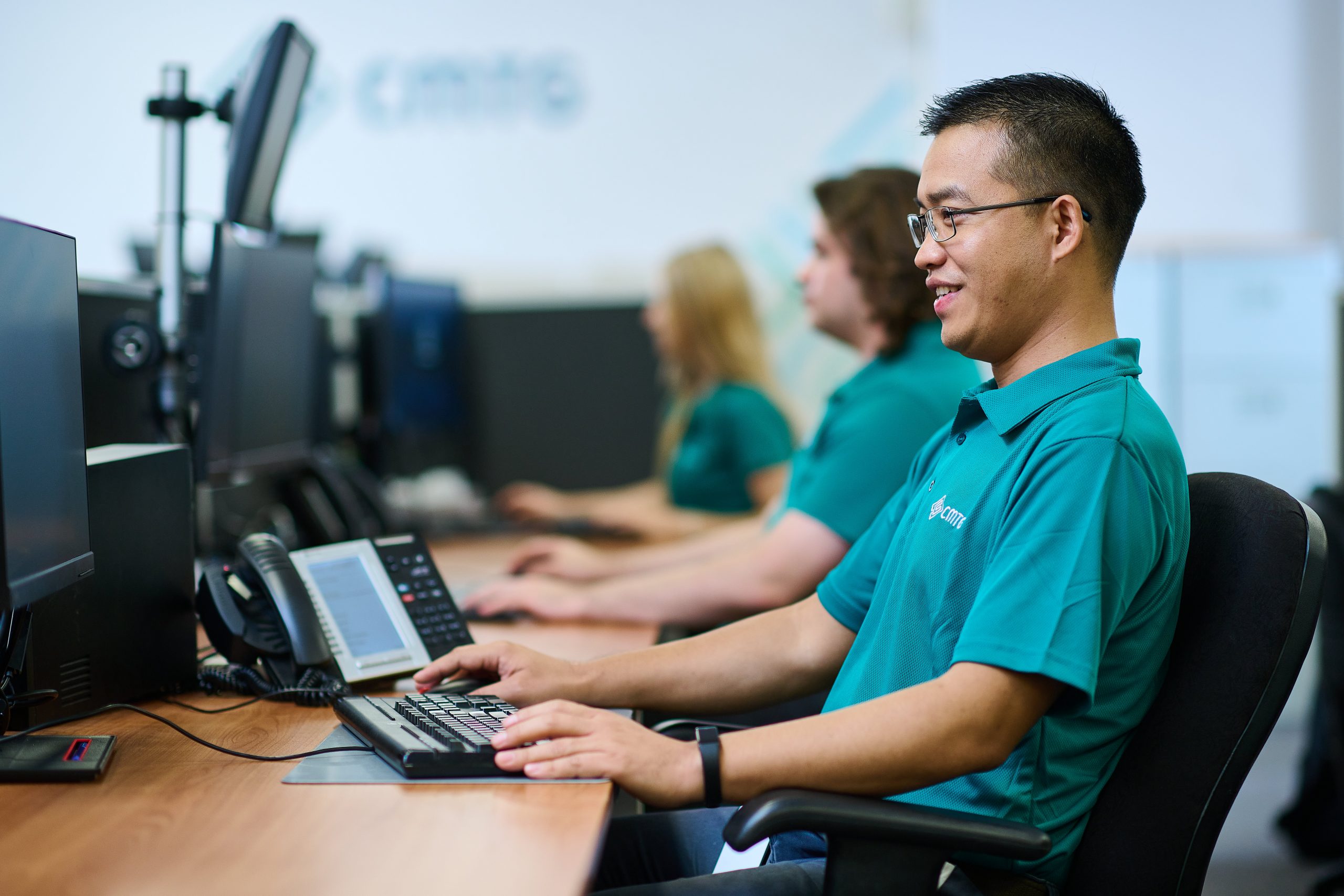 CMTG employee working at a computer, supporting cyber security Perth services and helping protect business systems from digital threats.