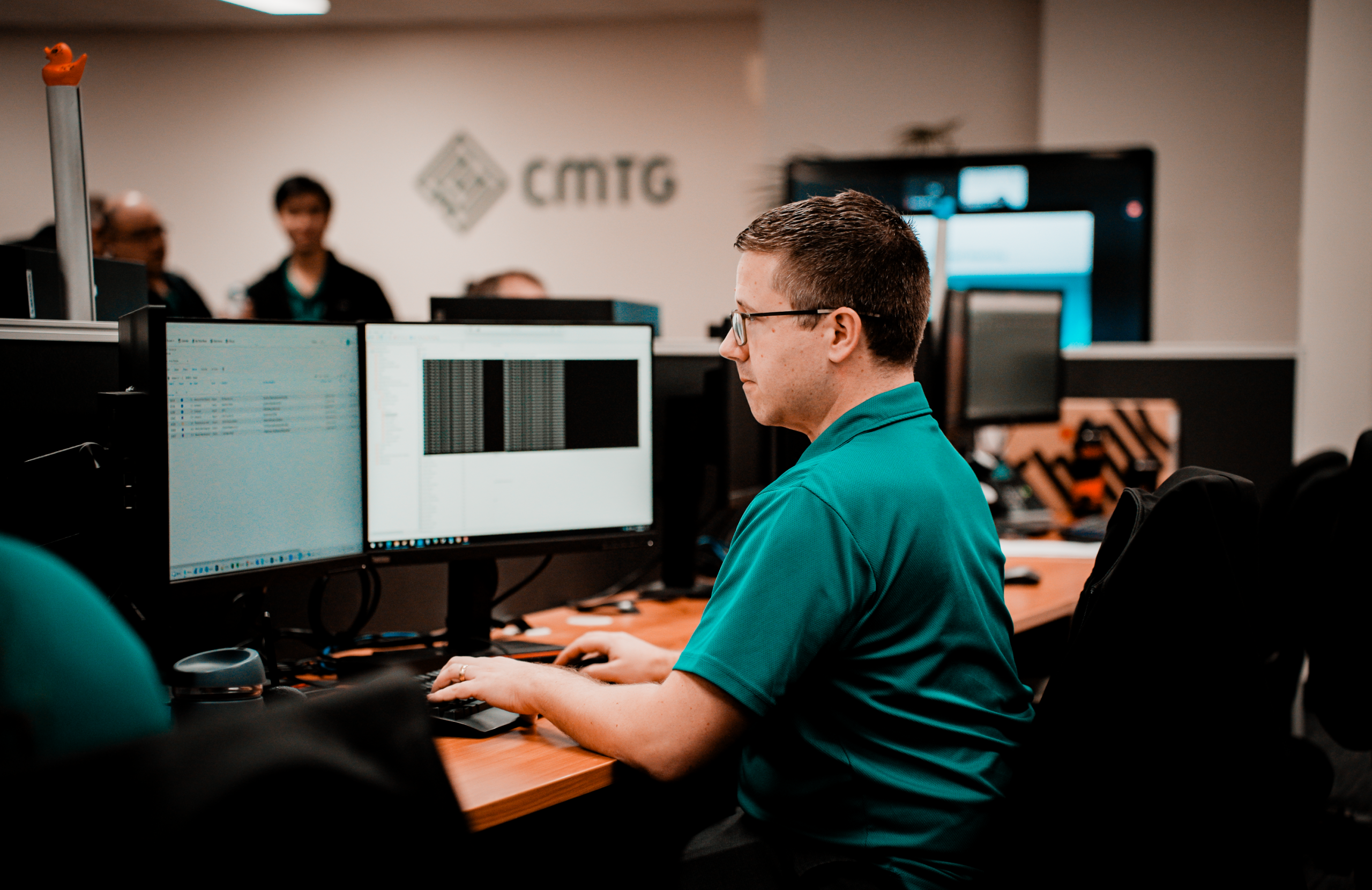 Cyber security Perth professional working on a computer at the CMTG office, supporting secure business systems and digital protection.