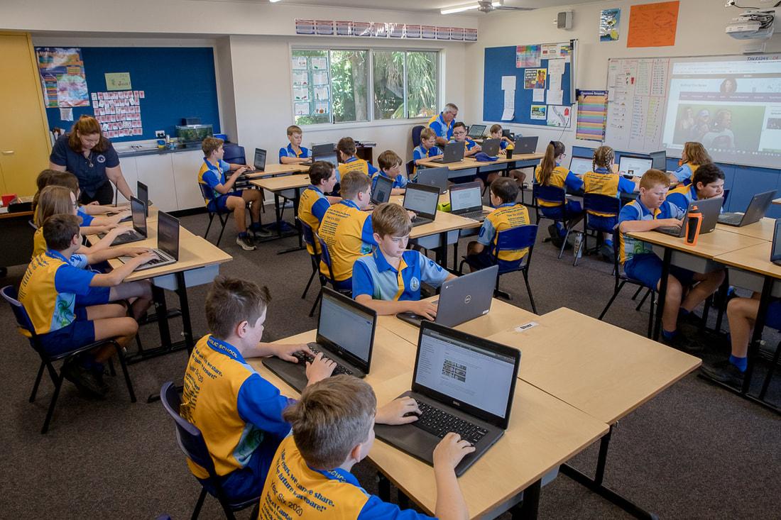 Students using laptops in a classroom supported by Microsoft 365 Backup Australia for secure education data protection.