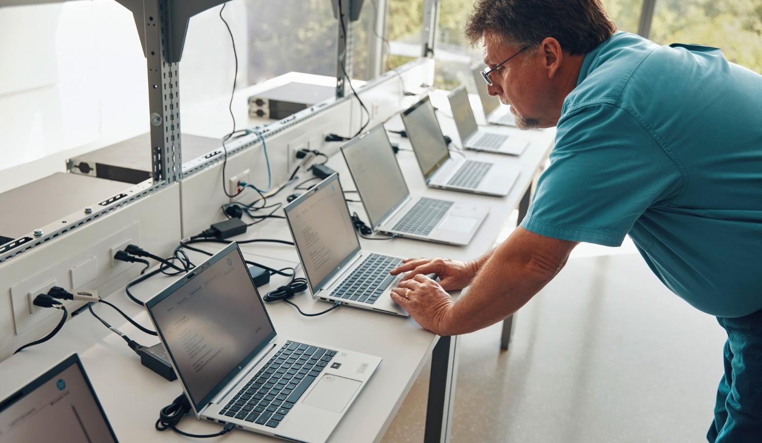 CMTG employee working on a laptop in a modern office, delivering IT support in Perth and hardware procurement services.