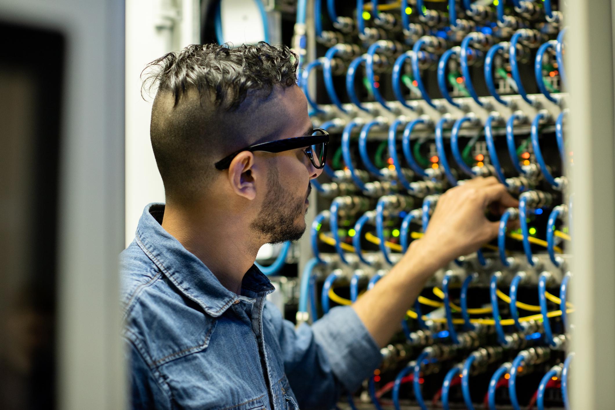 Man wearing sunglasses checking network connectivity for reliable business internet Perth solutions.